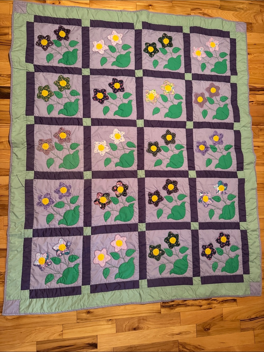 Floral Patchwork Quilt in Purple and Green
Hand sown by a family member